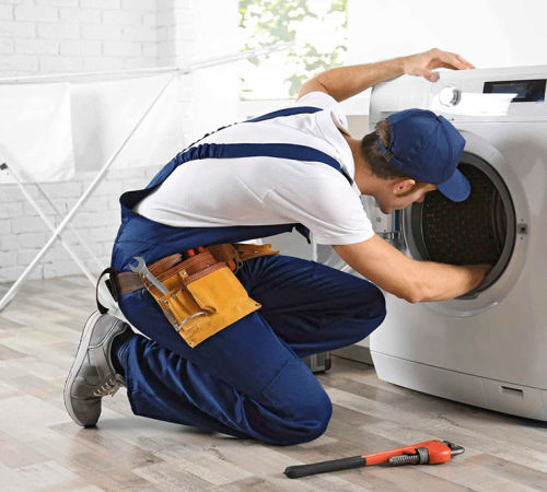 Technician performing professional washing machine repair service on a front-load washer