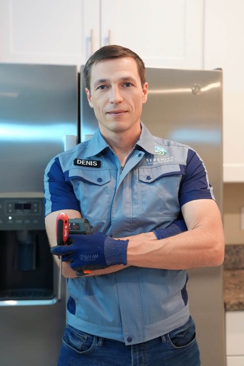Serenity Appliance Repair technician standing in a kitchen with professional appliance repair tools